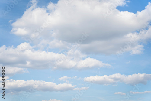White clouds on a blue sky background.