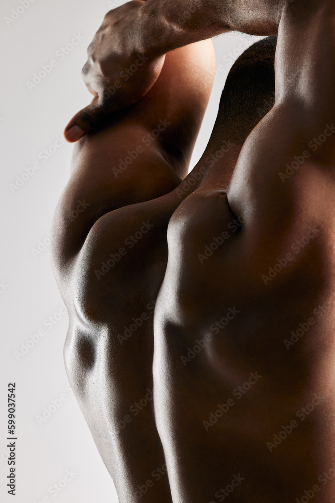 Are you becoming the person you want to be. Studio shot of a unrecognizable male flexing his back muscles against a grey background. Are you becoming the person you want to be. Studio shot of a unrecognizable male flexing his back muscles against a grey background.