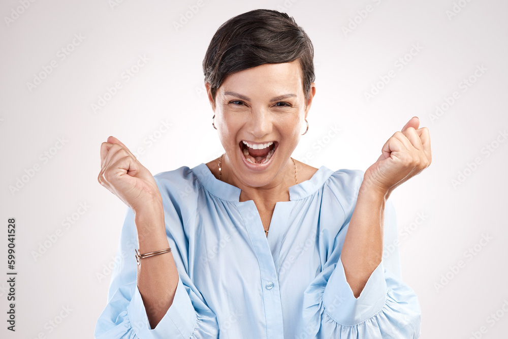 Success. Cropped portrait of an attractive young woman cheering in studio against a grey background. Success. Cropped portrait of an attractive young woman cheering in studio against a grey background.