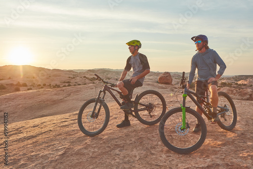 Ready for adventures on the trail. Full length shot of two young male athletes mountain biking in the wilderness.