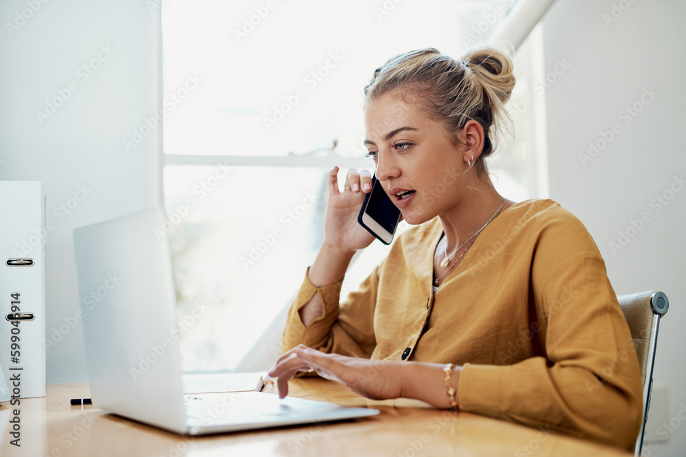 Im looking for it right now. an attractive young businesswoman sitting and using her cellphone while working on a laptop in the office. Im looking for it right now. an attractive young businesswoman sitting and using her cellphone while working on a laptop in the office.