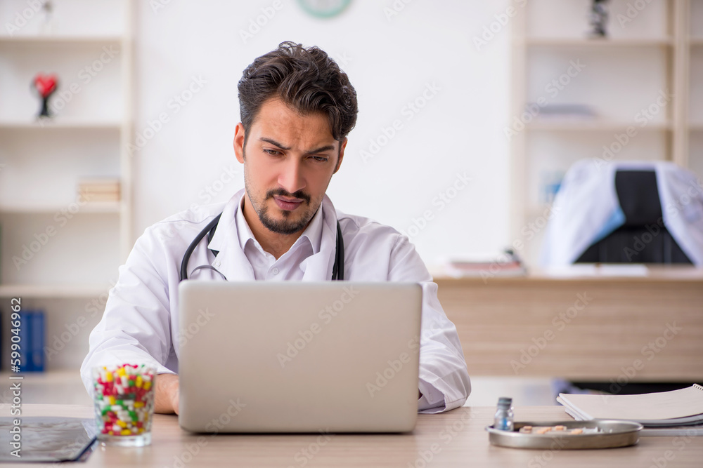 Young male doctor working in the clinic Young male doctor working in the clinic