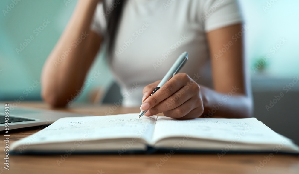 Planning my day. a young woman writing in a notebook at home. Planning my day. a young woman writing in a notebook at home.