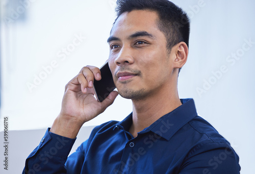 Reach out to your network if you need some help. a young businessman talking on a cellphone in an office.