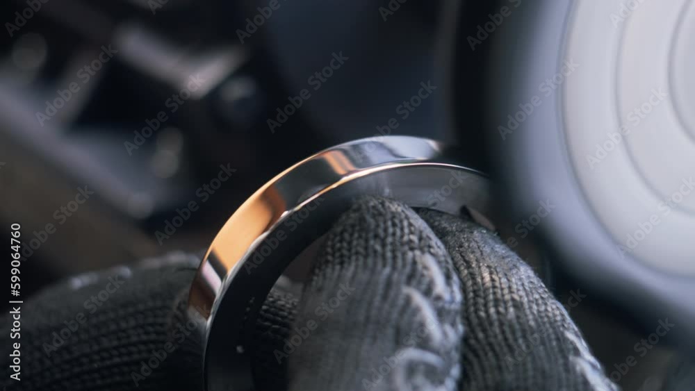 Close up shot of technician working on grinding machine with polishing disk while smoothing metal workpiece. Cinema lenses production on factory. Concept of manufacturing, industrial and Generative AI