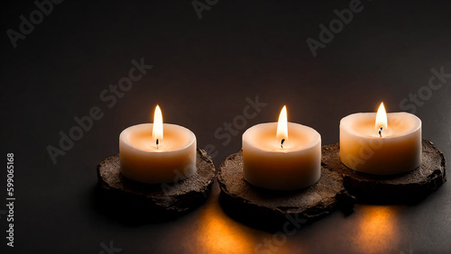 Three small burning candles black floor