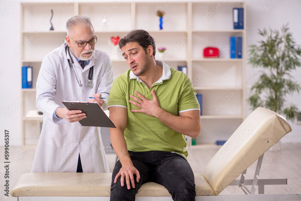 Young male patient visiting old male doctor Young male patient visiting old male doctor