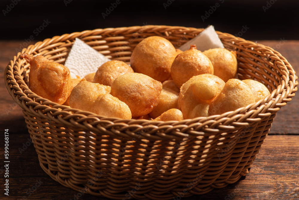 Raincake, basket with raincakes on rustic wood with black background, selective focus. Raincake, basket with raincakes on rustic wood with black background, selective focus.