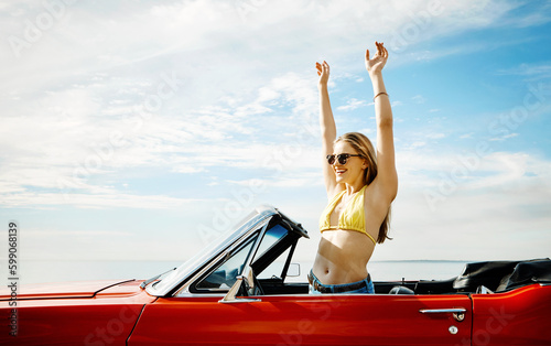 Make life a permanent vacation. a happy young woman enjoying a summers road trip.