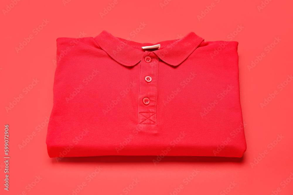 Folded red t-shirt on color background Folded red t-shirt on color background
