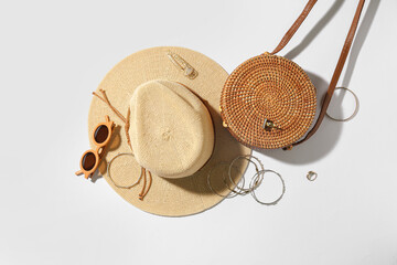 Jewelry with sunglasses, bag and summer hat on white background
