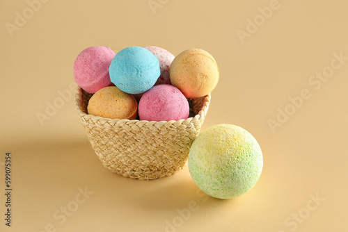 Basket with bath bombs on beige background