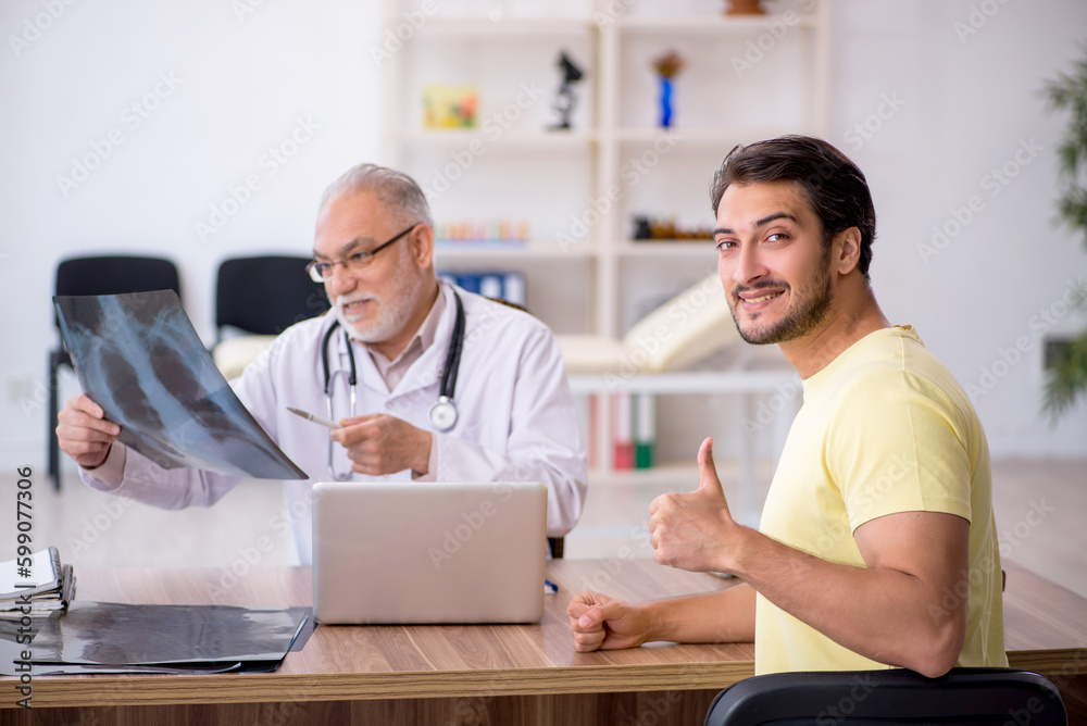 Young male doctor visiting old male doctor radiologist Young male doctor visiting old male doctor radiologist