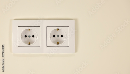 White double socket on the wall. The concept of electricity supply in the house.