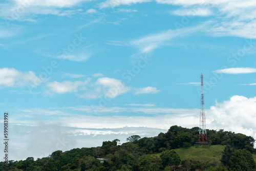 Communication antenna in the city and beautiful blue sky. Colombia.