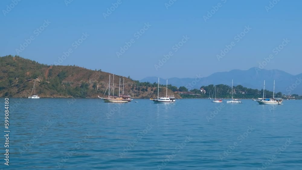 Yachts against stunning sea. A view of modern yachts view against blue sea and green hills. A concept of sea traveling during summer vacation. Generative AI Yachts against stunning sea. A view of modern yachts view against blue sea and green hills. A concept of sea traveling during summer vacation. Generative AI