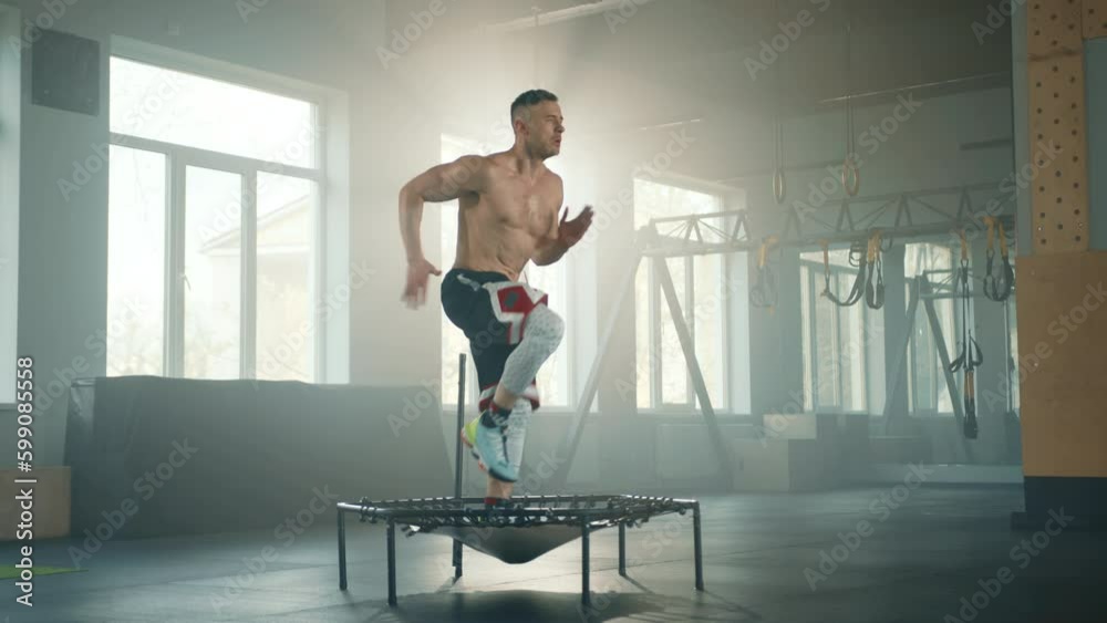 Young athletic man with bare torso running on fitness trampoline in gym. Sportsman fastens his running, moving hands back and force and shouts aloud. High quality 4k footage Generative AI