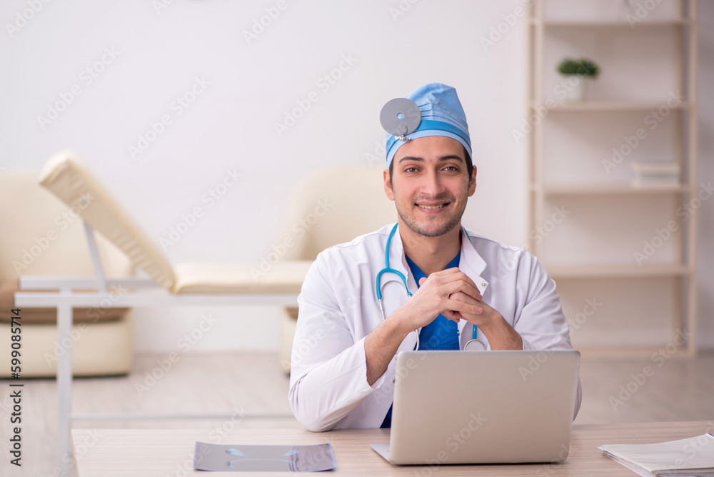 Young male doctor otologist working in the clinic Young male doctor otologist working in the clinic