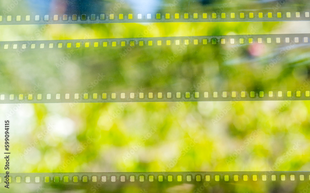 green nature in defocus and film strip for banner background.green background with film strip