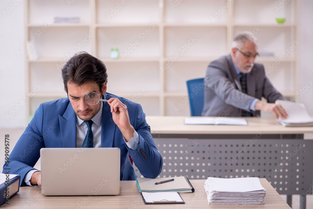 Two male colleagues working in the office Two male colleagues working in the office