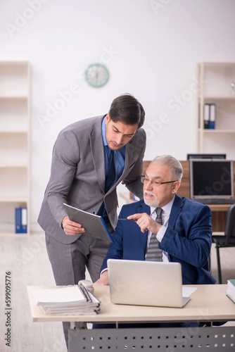 Two male colleagues working in the office