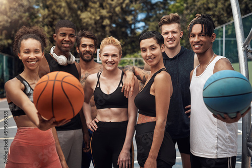 Participating in youth basketball is a fun way to build friendships. Portrait of a group of sporty young people standing together on a sports court.