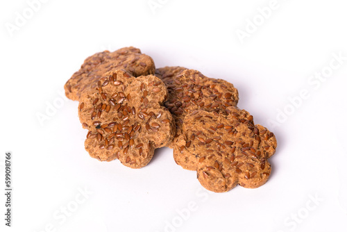 Fresh cookies with dried plums and caraway seeds on the white background