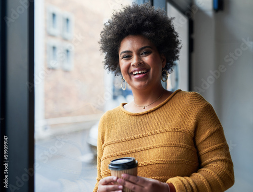Become your own role model in life. Portrait of an attractive young businesswoman drinking coffee and looking cheerful in her office at work.