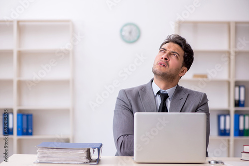 Young male employee working in the office