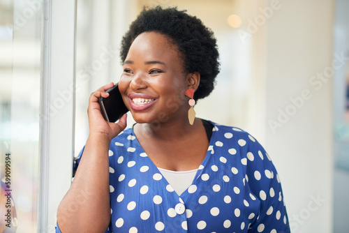 Im great and how are you. a young businesswoman using a smartphone in a modern office.