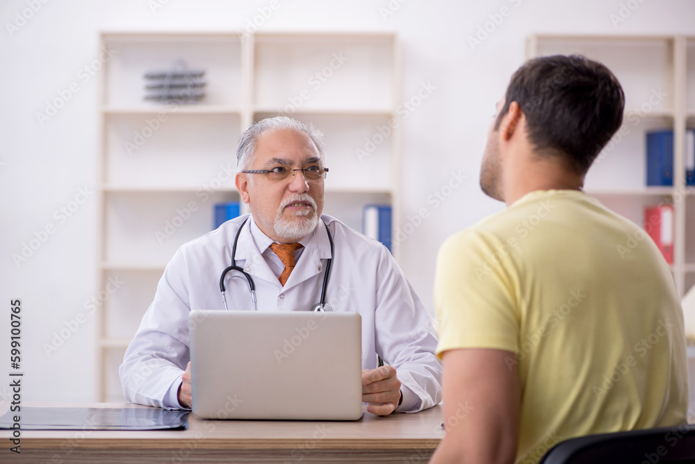 Young male patient visiting old male doctor Young male patient visiting old male doctor
