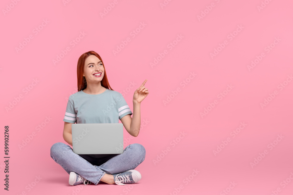 Smiling young woman with laptop on pink background, space for text Smiling young woman with laptop on pink background, space for text