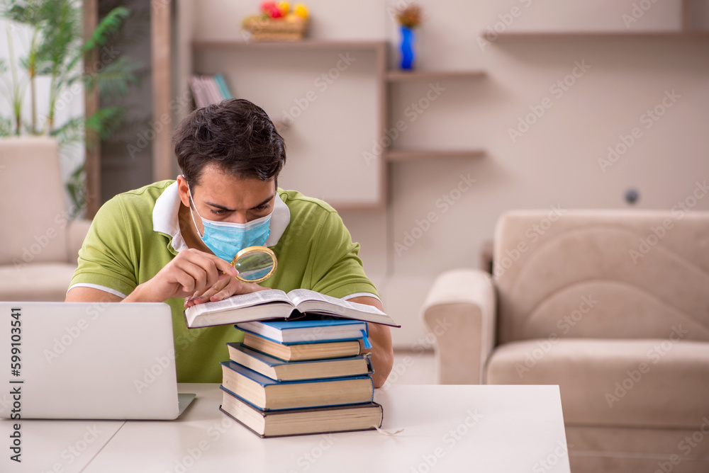 Young male student preparing for exams at home during pandemic Young male student preparing for exams at home during pandemic