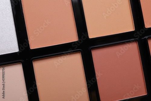 Colorful contouring palette as background  closeup. Professional cosmetic product