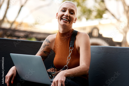 Happiness is my everyday mood. Portrait of an attractive young woman using a laptop while relaxing outdoors.