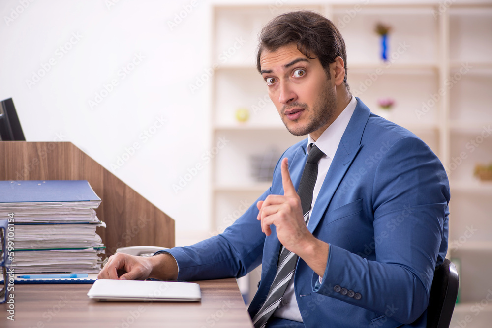 Young male employee working in the office Young male employee working in the office