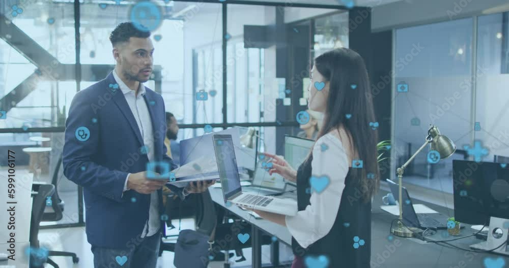 Animation of medical icons over diverse business people talking in office Animation of medical icons over diverse business people talking in office
