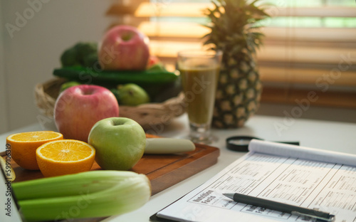 Diet plan paper and fresh vegetables and fruits on white table. Dieting, healthy lifestyle and right nutrition concept.
