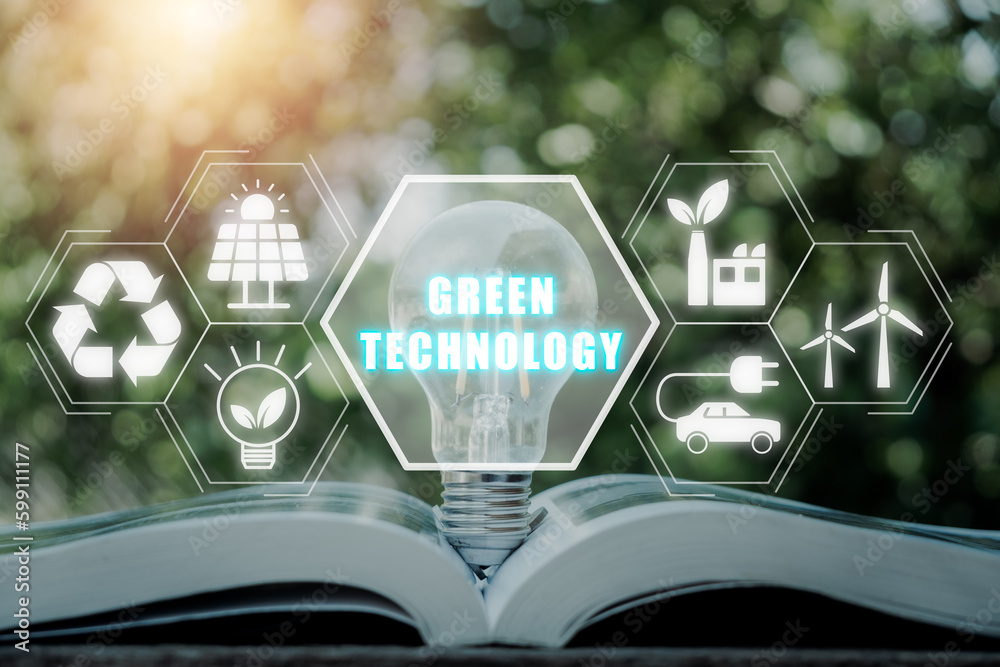 Green technology concept,  Light bulb on book with green technology icon on virtual screen.