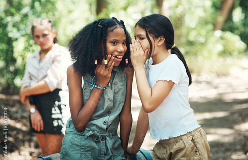 Not everyone is having fun. two teenage girls gossiping about their friend at summer camp. © Nicholas Felix/peopleimages.com
