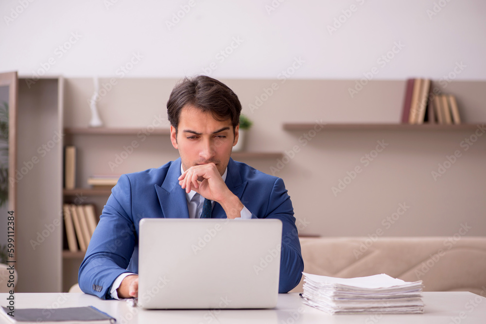 Young male employee working from home during pandemic Young male employee working from home during pandemic