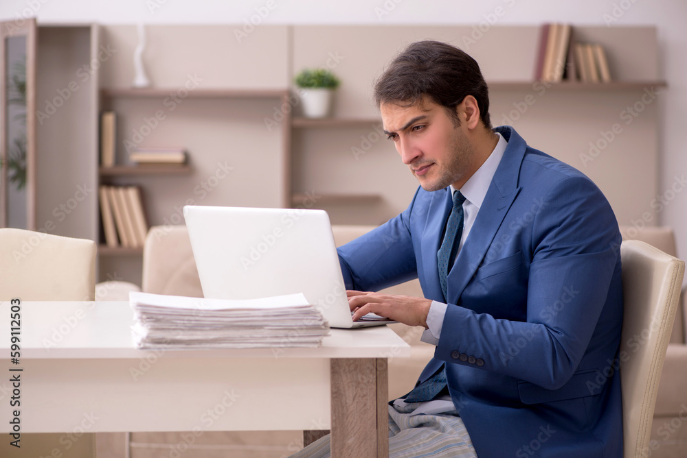 Young male employee working from home during pandemic Young male employee working from home during pandemic