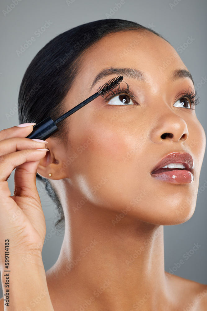 Mascara goes everywhere with me. a beautiful young woman applying mascara. Mascara goes everywhere with me. a beautiful young woman applying mascara.