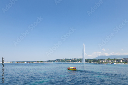 Geneva's main monument and landmark, the Jet d'Eau (Water Jet), taken in a summer afternoon with a blue sky. Geneva is one of the biggest financial places of Europe, and one of the economic centers of