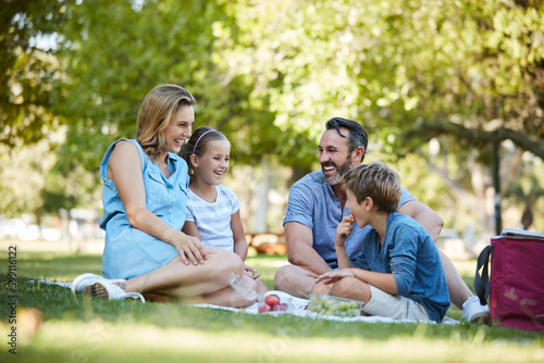 Do more things that make your family smile. a happy young family enjoying a picnic in the park.