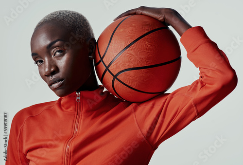 Give every game your all. Studio shot of an attractive young woman playing basketball against a grey background. © Nicholas Felix/peopleimages.com