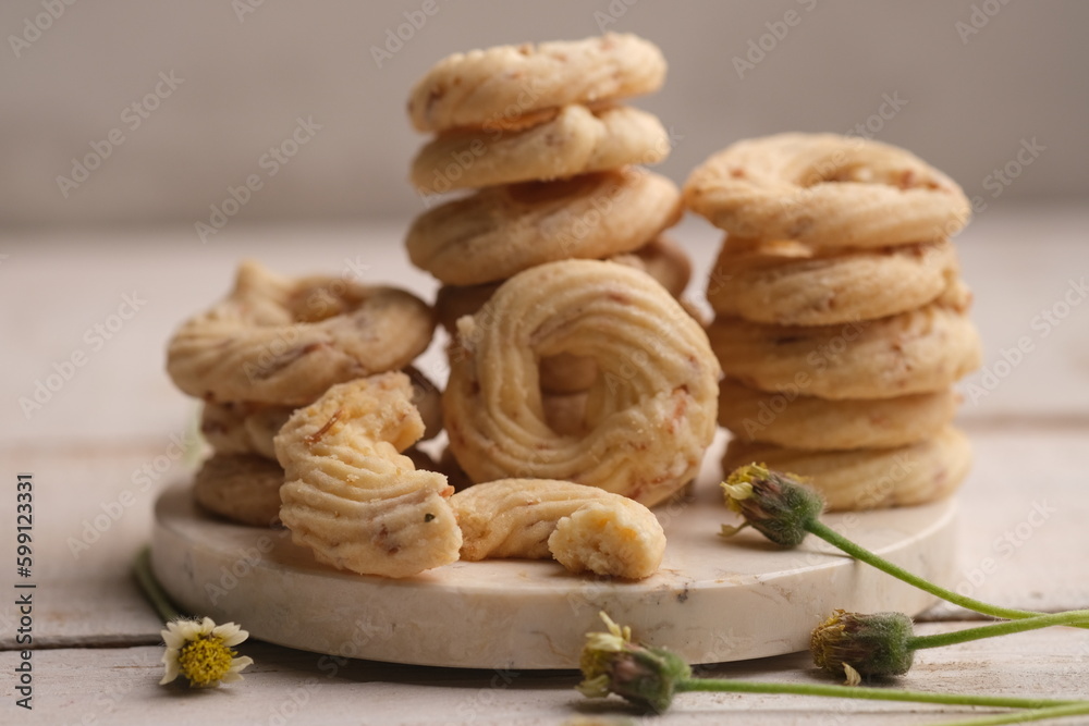 Cheese cookies on a white wooden table. Cookies are dry bread baked in the oven, made from wheat flour, eggs, sugar, cheese and other ingredients. White cheese cookie. sagu keju. sagoo cheese. Cheese cookies on a white wooden table. Cookies are dry bread baked in the oven, made from wheat flour, eggs, sugar, cheese and other ingredients. White cheese cookie. sagu keju. sagoo cheese.