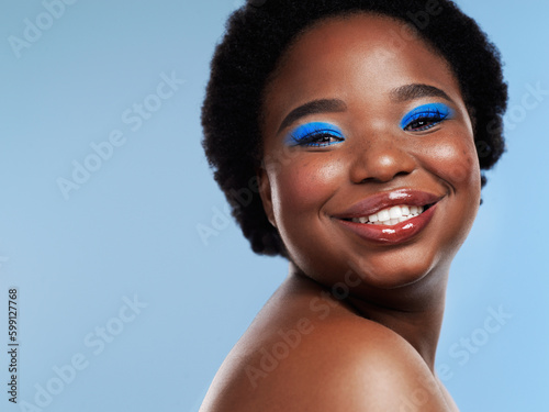 Smile your way to a beautiful day. Studio shot of a beautiful young woman posing against a blue background.