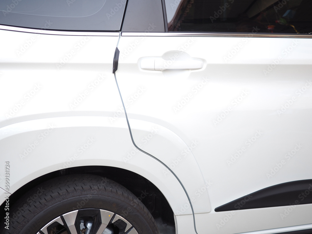 Rear side door and door handle of a new white car.