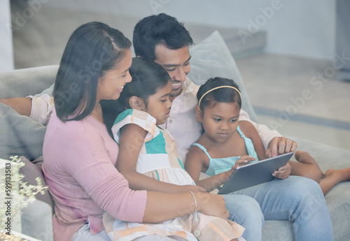 Spread love to receive it. a young family relaxing together while using a digital tablet.